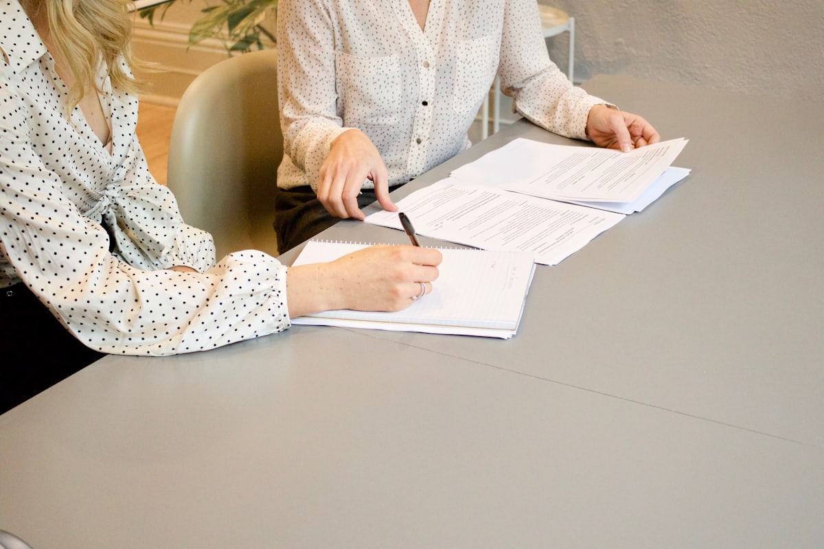 Program terms being reviewed and signed at a desk.